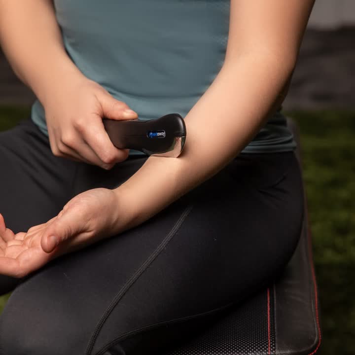 A pro using the Mini Scraper on her own forearm